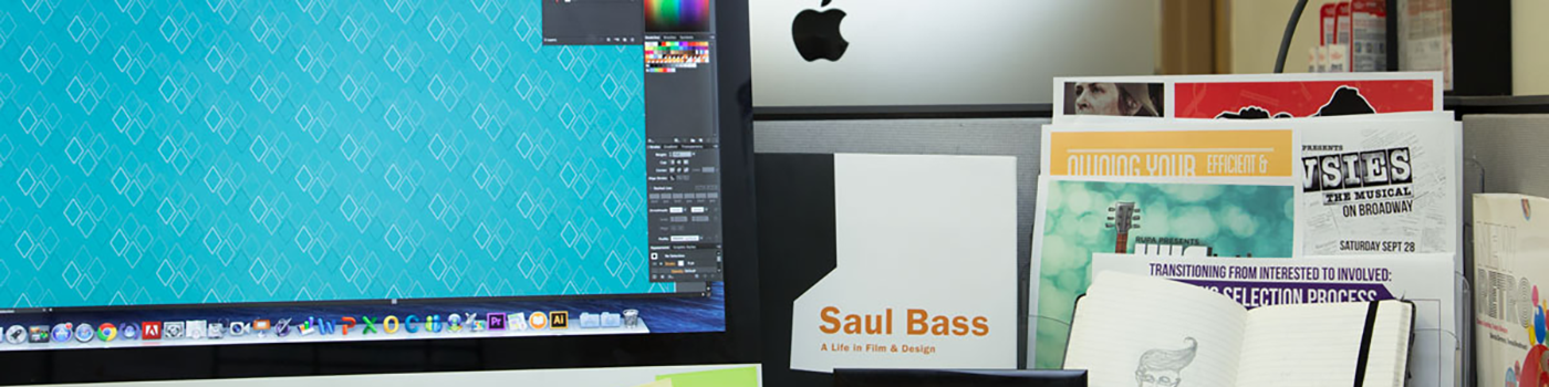 desk with imac and art